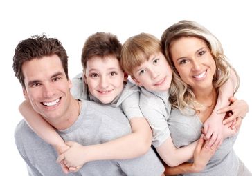 A family hugging looking at the camera